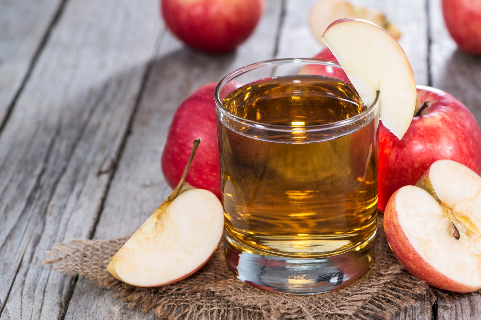 Apple Juice with fresh fruits on wooden background